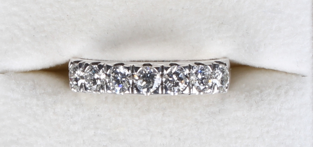 An 18ct white gold seven stone diamond ring, the brilliant cut diamonds arranged in a single row and