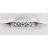 An 18ct white gold seven stone diamond ring, the brilliant cut diamonds arranged in a single row and