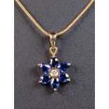 Property of a lady - an 18ct gold sapphire & diamond flowerhead pendant, on 18ct gold chain