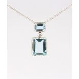 A platinum aquamarine & diamond pendant necklace, with two rectangular cut aquamarines in millegrain