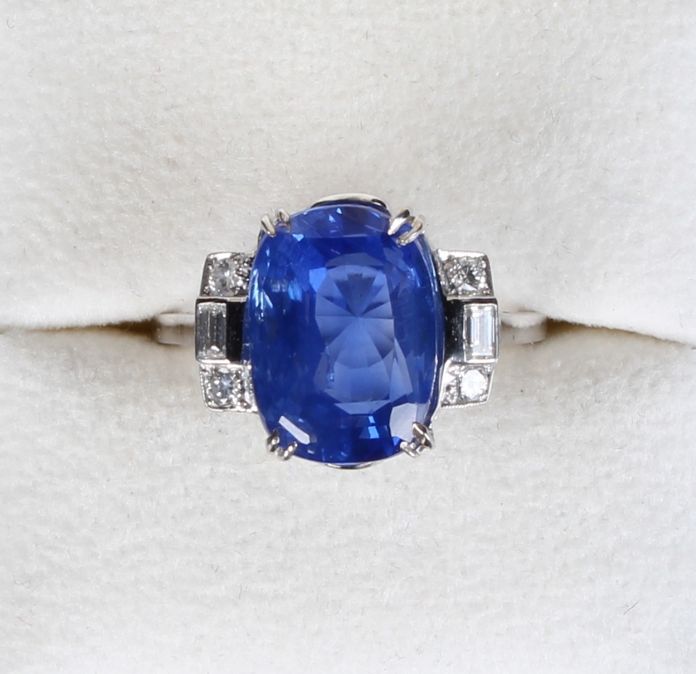A fine large unheated Ceylon sapphire & diamond ring, the oval cushion cut sapphire weighing 11.03