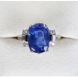 A fine large unheated Ceylon sapphire & diamond ring, the oval cushion cut sapphire weighing 11.03