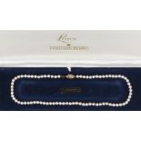 Property of a deceased estate - a boxed Lotus cultured pearl single row necklace, with 9ct gold