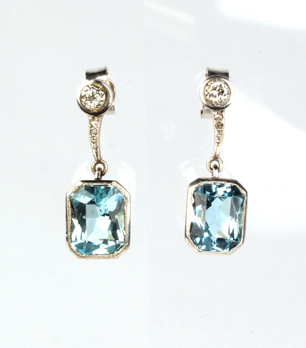 A pair of white gold aquamarine & diamond pendant earrings, each with a rectangular cut aquamarine