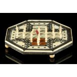 A late 19th century Indian sadeli decorated ivory & sandalwood octagonal games board, with turned