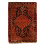 Property of a lady - an early 20th century Bidjar rug, with red ground & navy borders, 63 by