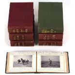 A green cloth photograph album containing photographs of Algiers, one per page, with manuscript