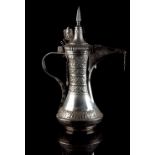 An Islamic white metal (tests silver) coffee pot, 15.25ins. (38.7cms.) high, approximately 1,900