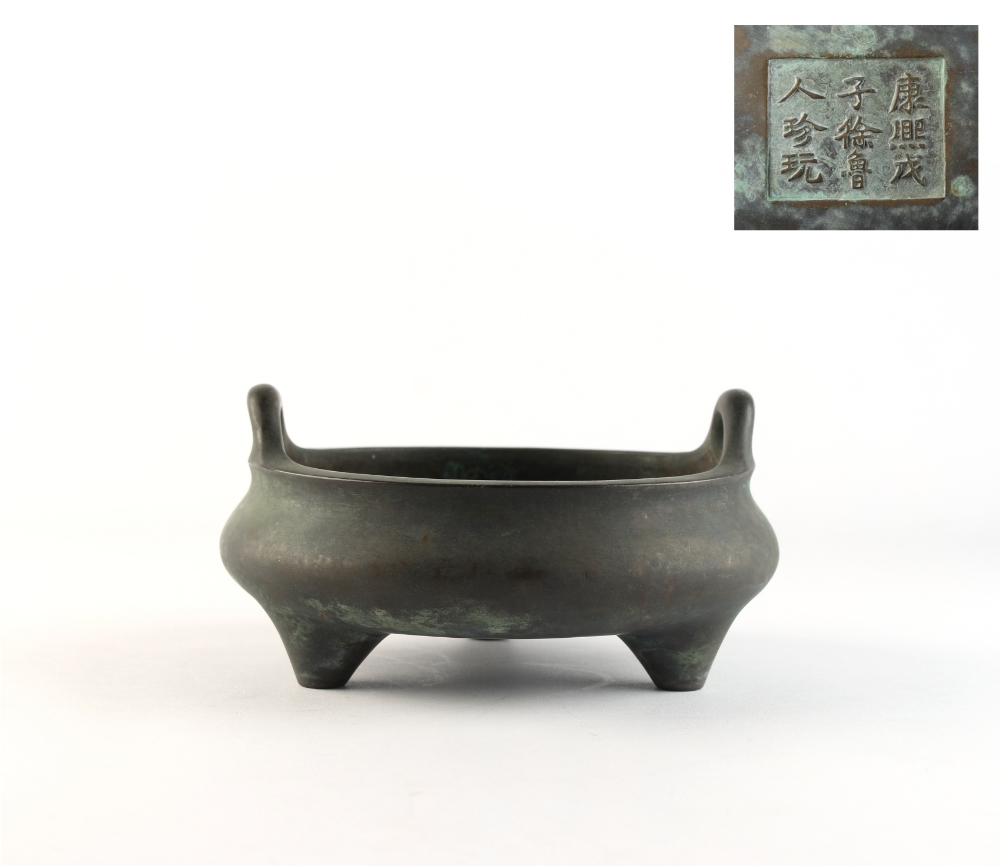 A Chinese bronze two-handled tripod censer, apocryphal Kangxi 9-character mark to base, 6.55ins. (