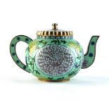 An early 20th century Chinese silver gilt & enamel teapot, decorated with chrysanthemums on a pale