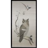 An early 20th century embroidered silk panel depicting a perched Owl, 39 by 20ins. (99.1 by 50.