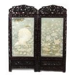 A late 19th century Chinese carved hongmu two-panel screen with embroidered silk panels depicting