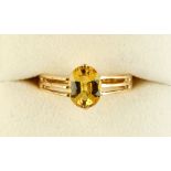 An 18ct yellow gold yellow sapphire solitaire ring, the oval cut yellow sapphire weighing an