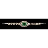 An emerald & diamond bar brooch, circa 1925, the rectangular cut vivid green emerald weighing