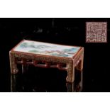 A Chinese famille rose miniature stand modelled as a kang table, painted with a pavillion in