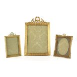 A late 19th century French ormolu rectangular framed easel photograph frame, with ribbon & wreath