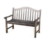 Property of a deceased estate - a weathered teak garden bench, with arched back, 48.5ins. (