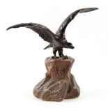 Property of a lady - an early 20th century brown patinated bronze model of an eagle perched on a