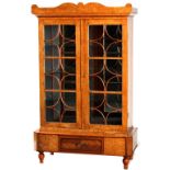 Property of a lady - a Russian Karelian birch glazed two-door bookcase, first half 19th century,