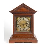 Property of a gentleman - an Edwardian carved mitre cased mantel clock, with Junghans movement '