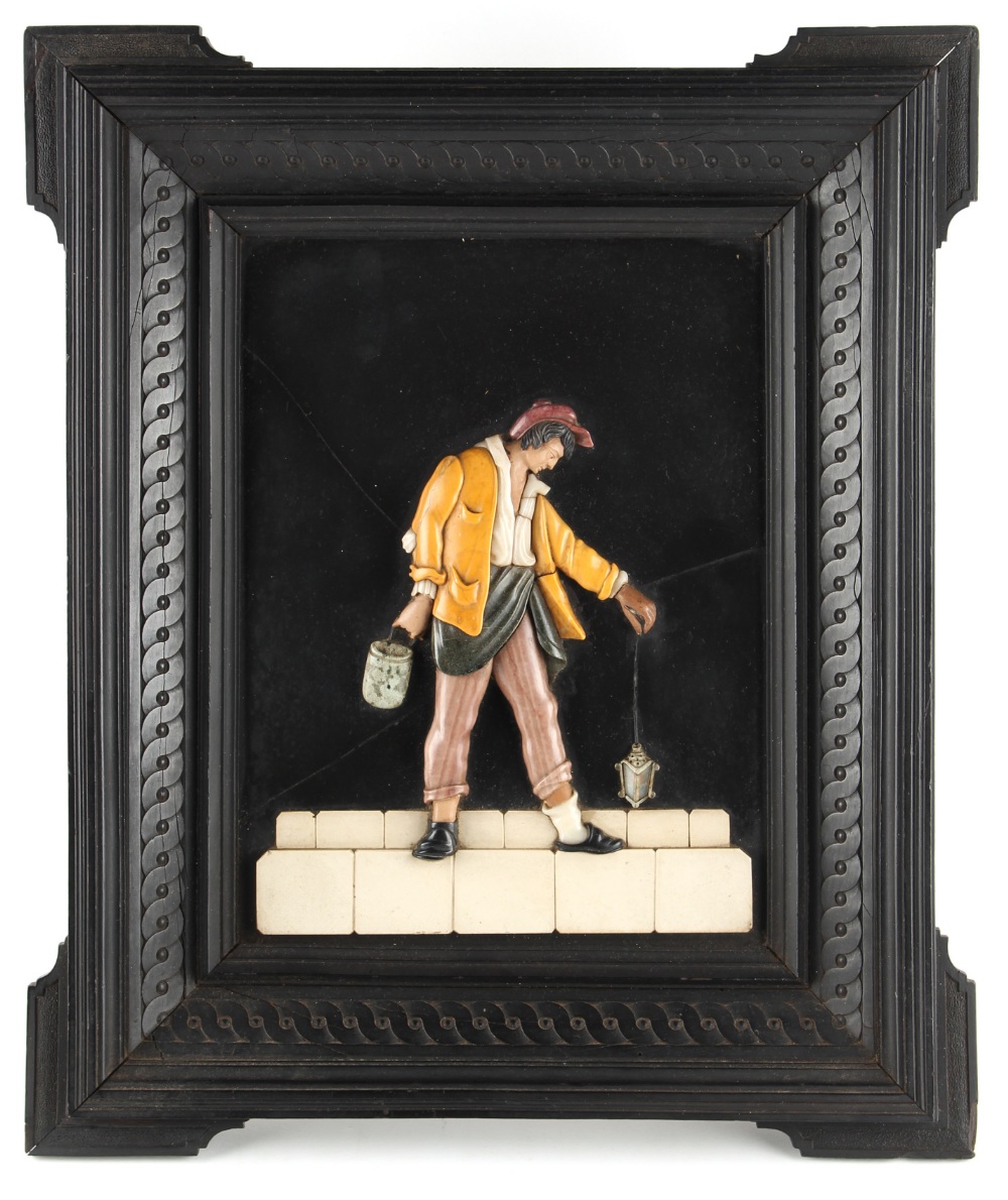 A 19th century Italian pietra dura plaque depicting a man holding a lantern, in carved ebony eared