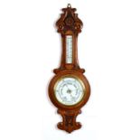 Property of a deceased estate - a late Victorian carved oak cased aneroid barometer & thermometer,