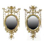 Property of a deceased estate - a pair of late 19th century gilt oval framed wall mirrors with