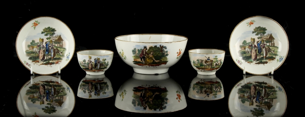 A pair of first period Worcester colour transfer printed tea bowls and saucers, decorated with