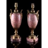 Property of a deceased estate - a pair of gilt metal mounted pink marble table lamps, with satyr