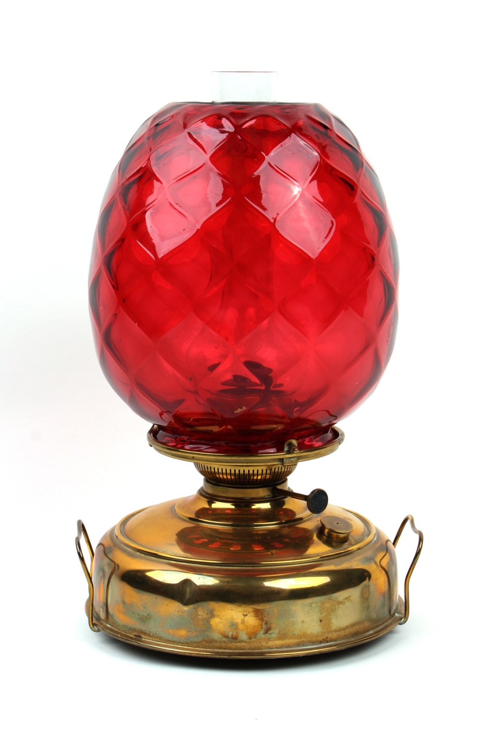 Property of a deceased estate - a brass paraffin oil lamp with large lattice moulded ruby glass