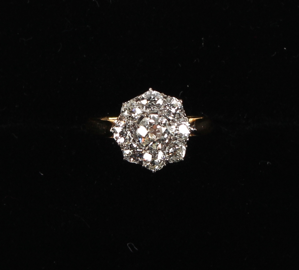 An 18ct yellow gold diamond cluster ring, the nine old European cut diamonds weighing a total of