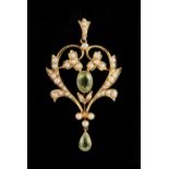 An Edwardian yellow gold peridot & seed pearl pendant, of openwork foliate form, 1.95ins. (5cms.)