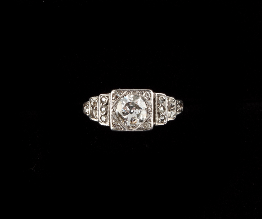 A platinum diamond ring, the central diamond weighing approximately 0.75 carat, in square setting