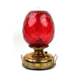 Property of a deceased estate - a brass paraffin oil lamp with large lattice moulded ruby glass