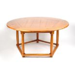 Property of a gentleman - a Continental chestnut circular topped dining table with five turned