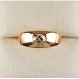 An 18ct yellow gold gipsy set diamond solitaire ring, the modern brilliant cut diamond weighing