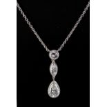 A fine platinum three stone diamond pendant necklace, the three stones each of a different cut,