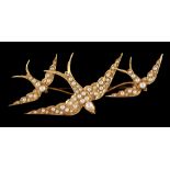 A late 19th / early 20th century 15ct yellow gold brooch modelled as three swallows set with seed