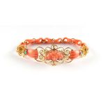 A unusual yellow metal mounted carved pink coral link bracelet modelled as two hands flanking a