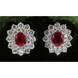 A pair of ruby & diamond oval cluster earrings, the two oval cut Burmese rubies weighing
