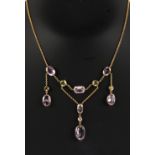 A pretty yellow gold pink topaz, chrysolite & diamond necklace, 14.75ins. (37.5cms.) long (see