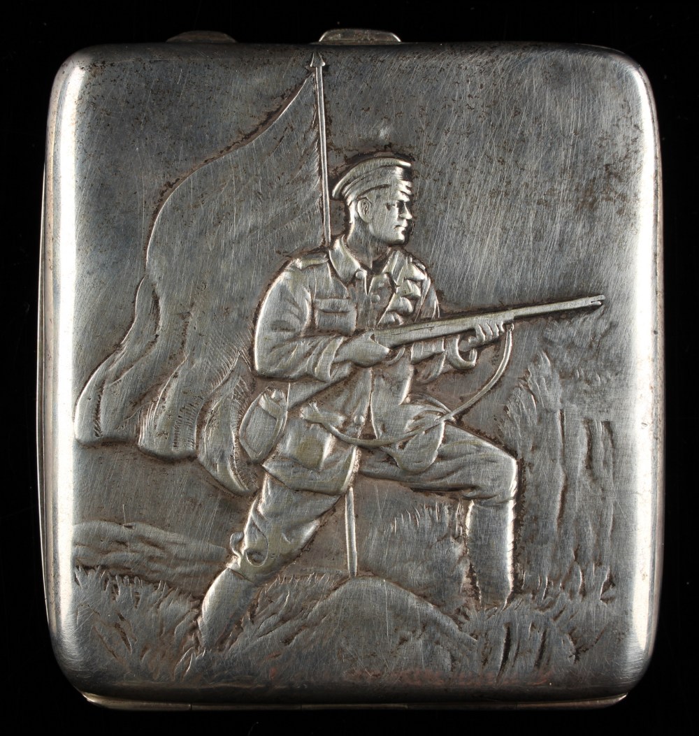 An early 20th century Russian silver cigarette case, decorated in relief with an infantry soldier