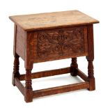 Property of a lady - a reproduction carved oak box stool, 20.25ins. (52cms.) long (see