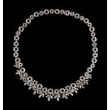 A fine French diamond necklace, with diamond set stylised flowerhead links of two alternating