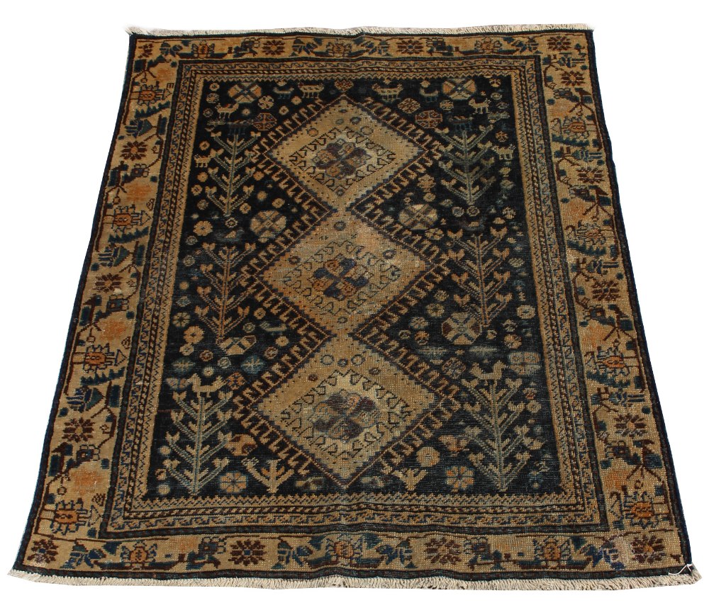 A Hamadan woollen hand-made rug with blue ground, 52 by 39ins. (133 by 100cms.) (see illustration).