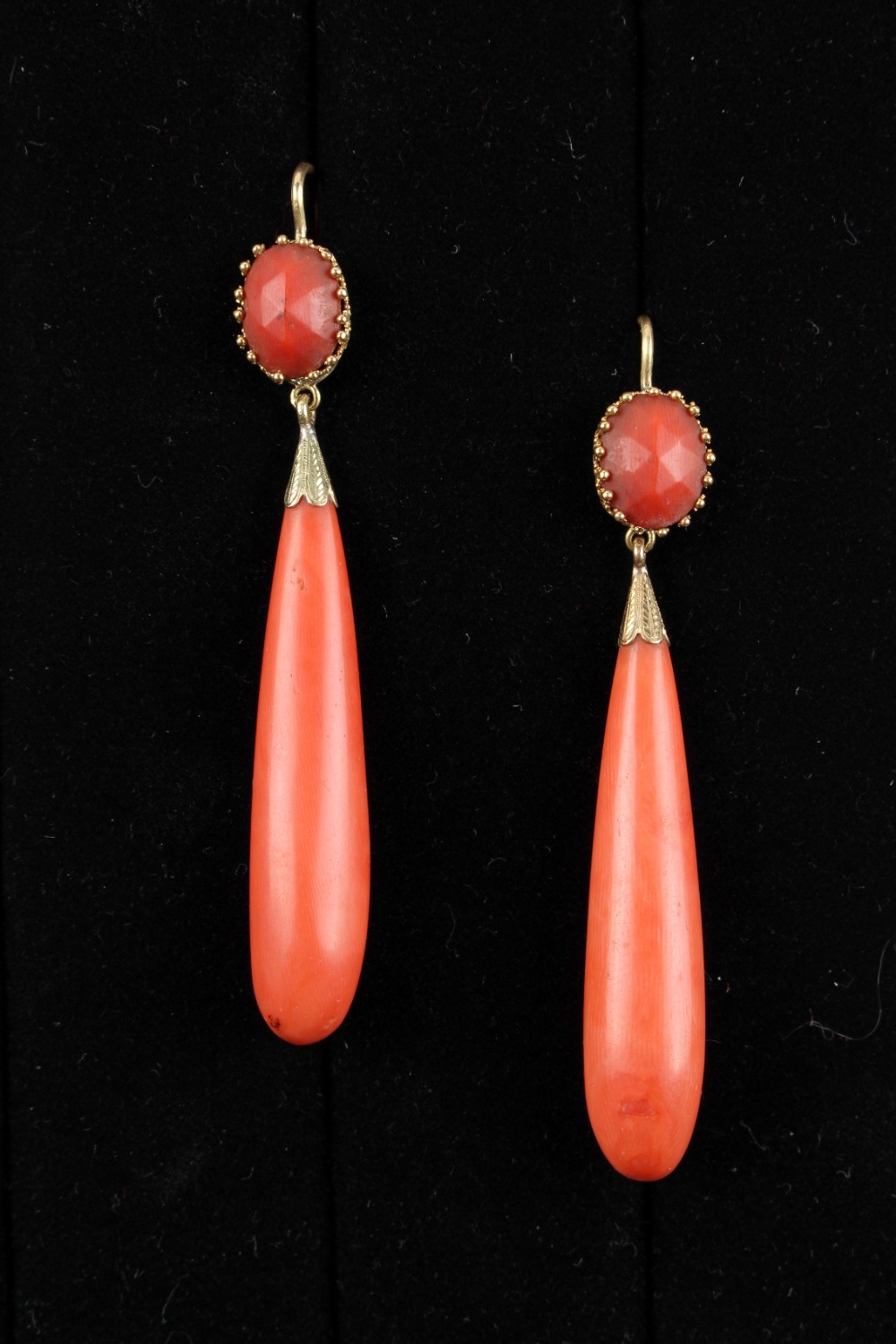 A pair of coral long pendant earrings, each 2.95ins. (7.5cms.) long (overall) (2) (see