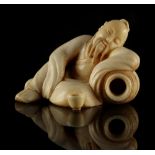 A Chinese carved ivory figure of a sleeping scholar, late 19th century, 2.2ins. (5.6cms.) long, on