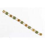 A Chinese 18ct yellow gold & jadeite circular panel bracelet, 7.6ins. (19.2ms.) long,