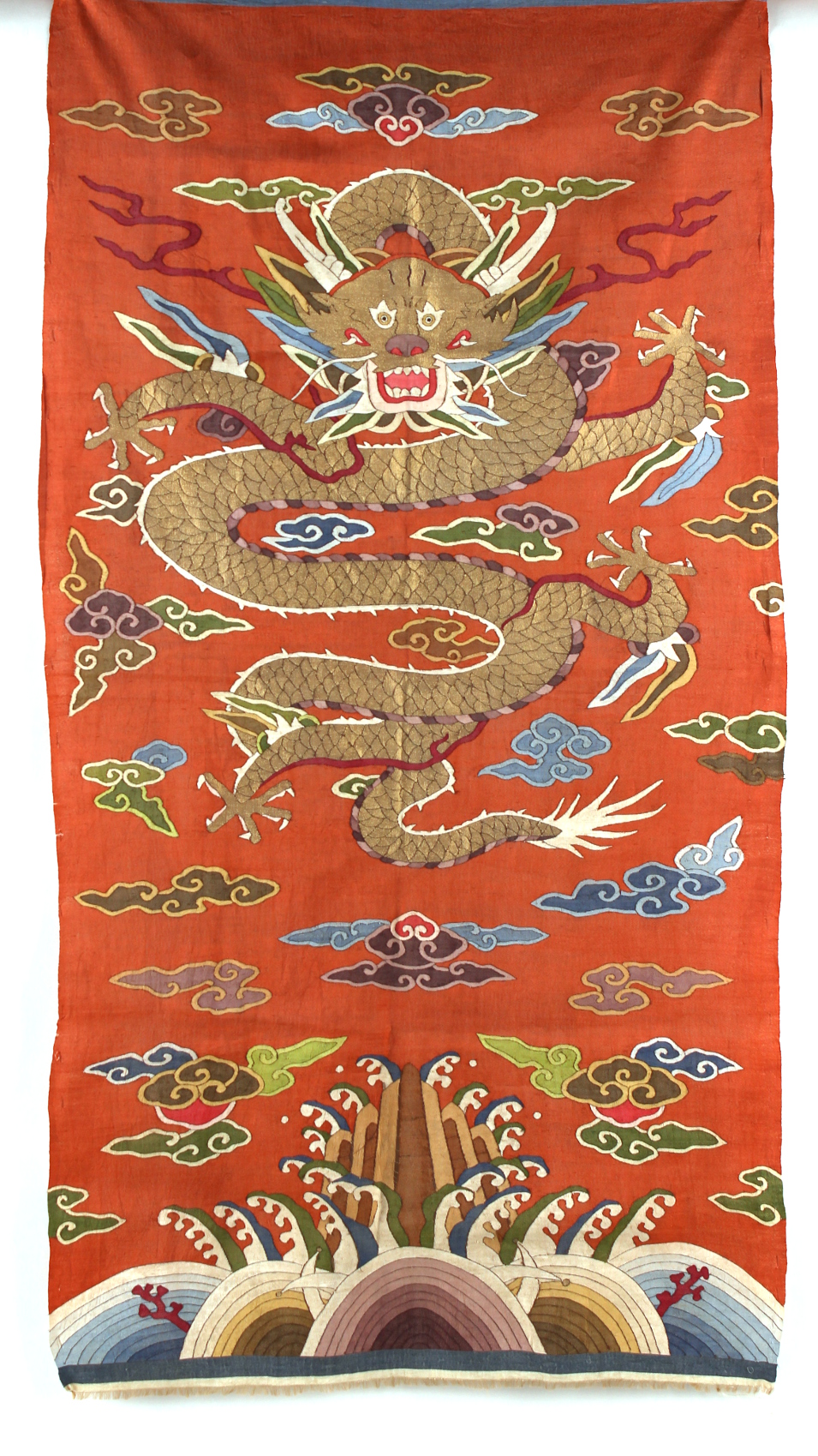 An early 20th century Chinese kesi brick red silk dragon panel, unframed,