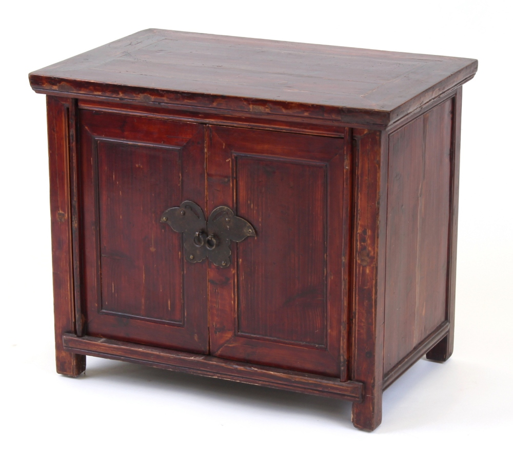 Property of a lady - a Chinese red stained softwood panelled two-door side cabinet, late 19th /